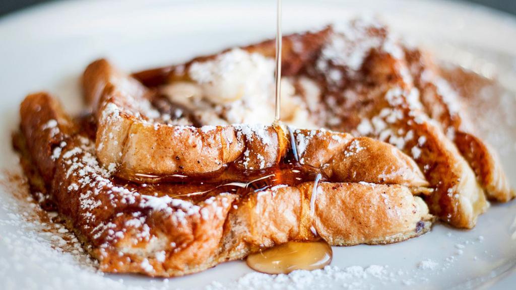 French Toast · Thick bread slices soaked in a rich egg mixture and griddled until golden perfection. Served with maple syrup. Choose as many add ons as you'd like.