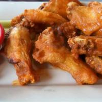 Buffalo Wings · Delicious flavorful wings, deep-fried unbreaded chicken wings coated with a vinegar-and-caye...