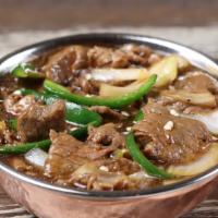 Chili Beef · Stir-fried beef in a Manchurian sauce, onion & green chili. Hot and spicy.
