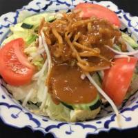 Thai Salad · House salad with lettuce, tomatoes, cucumbers, red onions, bean sprouts, and tofu, with pean...