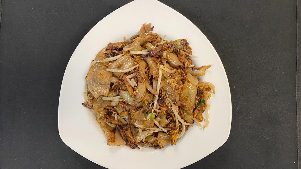 Duck Noodles · Stir-fried, shredded duck with broad rice noodles, red onions, white onions, scallions, bean sprouts, and egg.