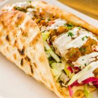 Veggie Pita Sandwich · Hummus, banjan, mixed greens, and white sauce. Served in a pita with lettuce, tomatoes, onio...