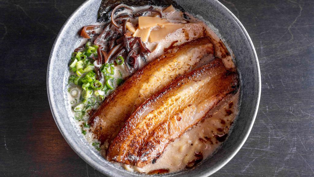 Tonkotsu Ramen · Rich & creamy pork broth | braised pork belly | kikurage mushroom | scallion | black garlic oil | bamboo | seaweed.