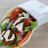 Falafels On A Pita  · Falafels on a pita with lettuce, tomato and onion with hummus spread
