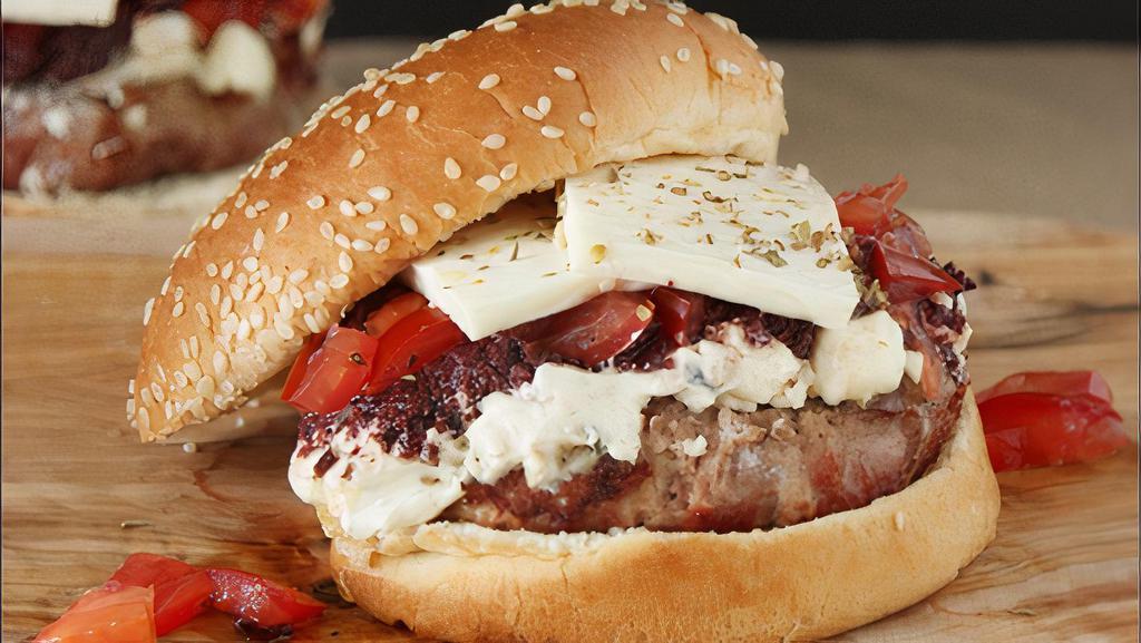 Greek Burger · Greek herbs seasoned with a half pound burger on a French brioche pasted with tzatziki and feta cheese.