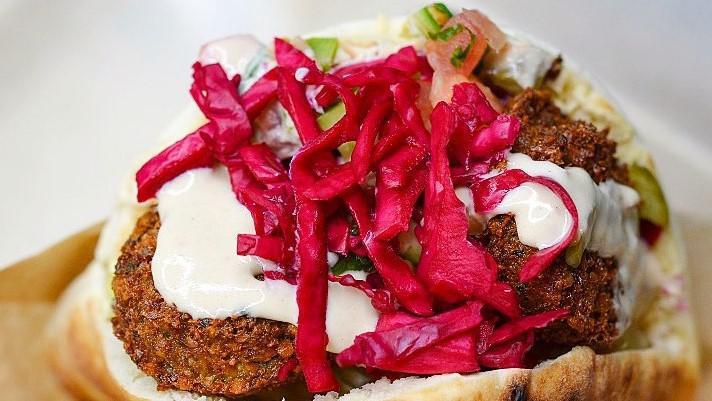 Falafel Pita Sandwich · Vegan. Hummus, red cabbage, Israeli salad, Israeli pickles and tahini. Vegan.