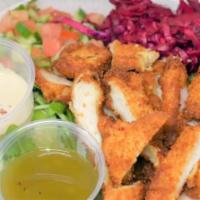 Schnitzel Salad · Mixed lettuce and arugula, Israeli salad, red cabbage and Israeli pickles.