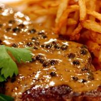 Steak Au Poivre · Certified black angus NY strip steak, confit broccoli, ultimate crispy fries, green pepperco...