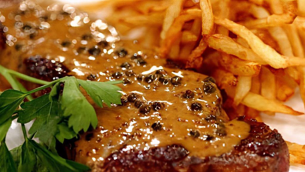 Steak Au Poivre · Certified black angus NY strip steak, confit broccoli, ultimate crispy fries, green peppercorns, Hennessy VSOP cream sauce.
