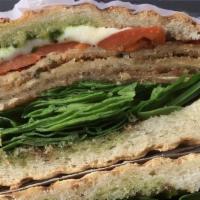 Caprese Panini · Breaded eggplant with roasted peppers, fresh mozzarella, fresh spinach leaves, and a pesto b...