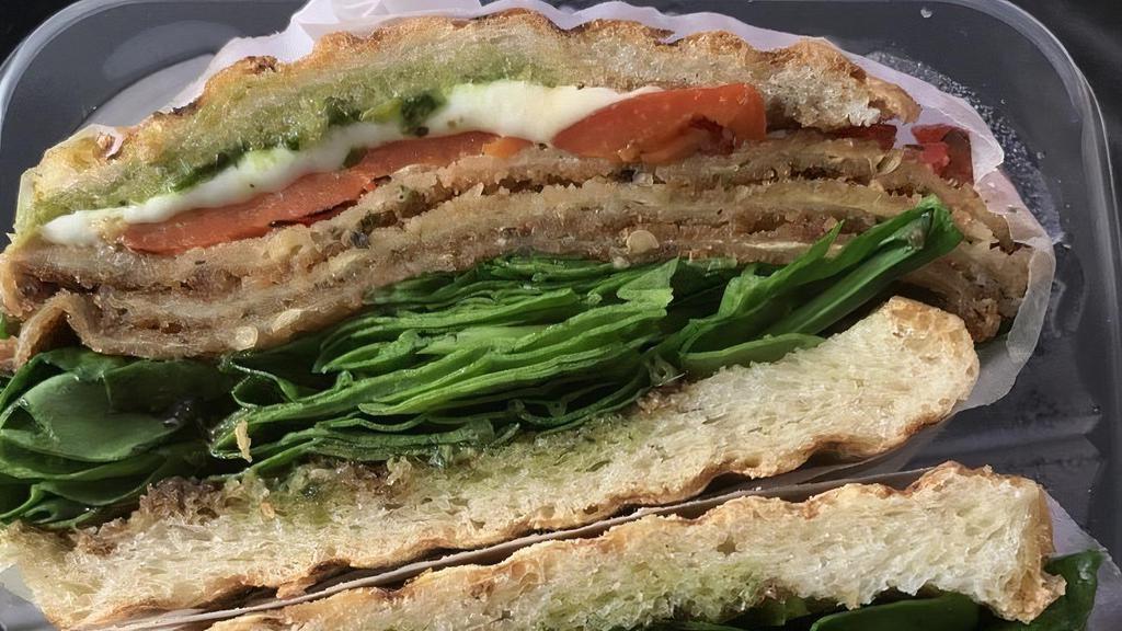 Caprese Panini · Breaded eggplant with roasted peppers, fresh mozzarella, fresh spinach leaves, and a pesto balsamic glaze.