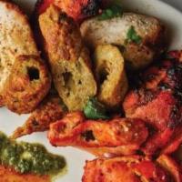Non Veg Mix Grill Tandoori · A delicious combination of grilled chicken, seekh kebab, malai kabab and chicken tikka.