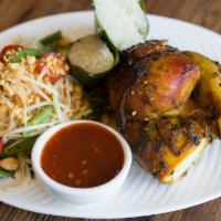 Gai Kamin Somtum · Grilled marinated half chicken, papaya salad, and coconut sticky rice. Served with chili-lim...