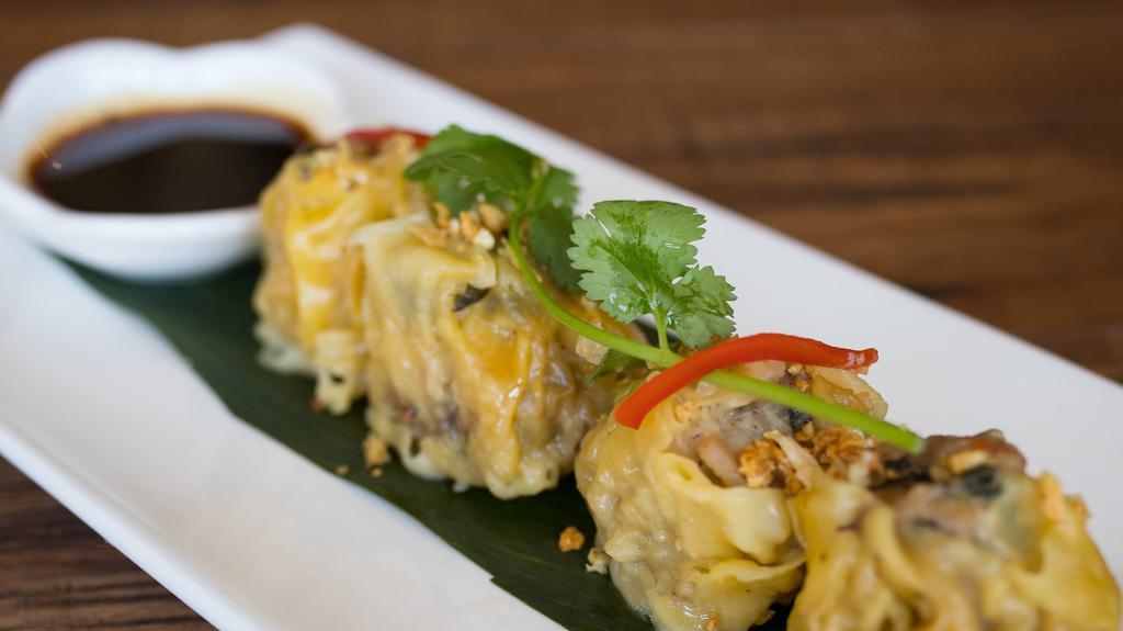 Thai Steamed Dumplings · Ground chicken, shrimp, water chestnuts, and shiitake mushrooms. Served with tangy soy sauce.