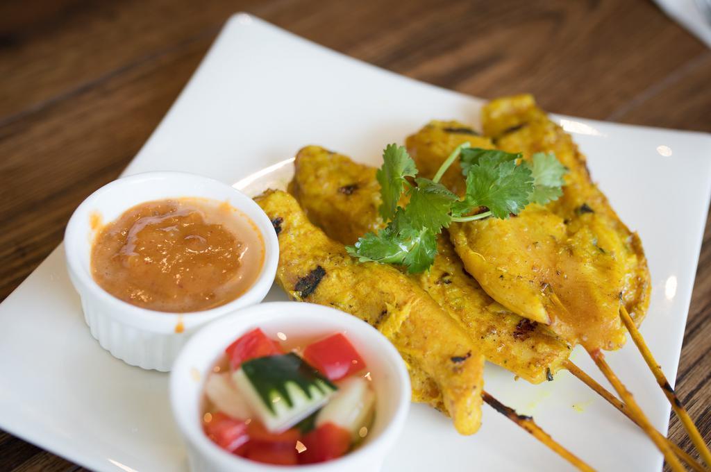Chicken Satay · Grilled marinated chicken on skewers, served with peanut sauce, and cucumber relish.