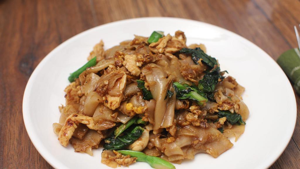 Pad Se-Ew · Broad noodles, Chinese broccoli, and a fried egg with thick soy sauce.