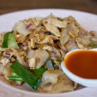 Kua Gai · Broad noodle, red onion, scallion, fried egg, and sesame oil.