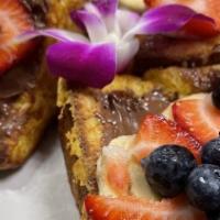 Honey Acai French Toast · With strawberries, blueberries, bananas and granola topped with honey.