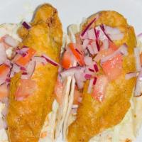 Pescado Taco · Fish batter seasoned with Peruvian beer and panca chile, served with cabbage and avocado dip...