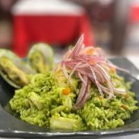 Arroz Con Mariscos Green · Rice with mix seafood topped with sarsa criolla in a green cilantro base sauce.