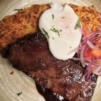 Skirt Steak Tacu Tacu · Skirt steak with rice and beans tamal served with fried egg, finished with red wine reductio...