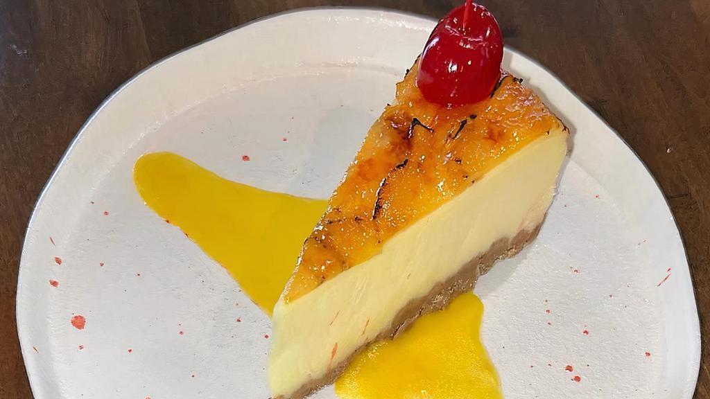Cheesecake Caramelized With Banana · Twist on a classic dessert with caramelized banana and passion fruit aji amarillo sauce.