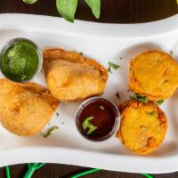 Vegetable Samosa (2 Pcs) · A world-known Indian street food. Golden crispy triangle baked pastry with savory potatoes a...