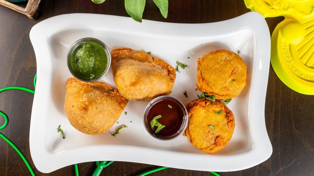 Vegetable Samosa (2 Pcs) · A world-known Indian street food. Golden crispy triangle baked pastry with savory potatoes and peas filling.