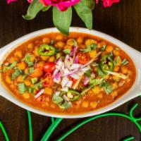 Chana Masala · Chick peas slow simmered with freshly ground onions, tomatoes, ginger & garlic Punjabi style.