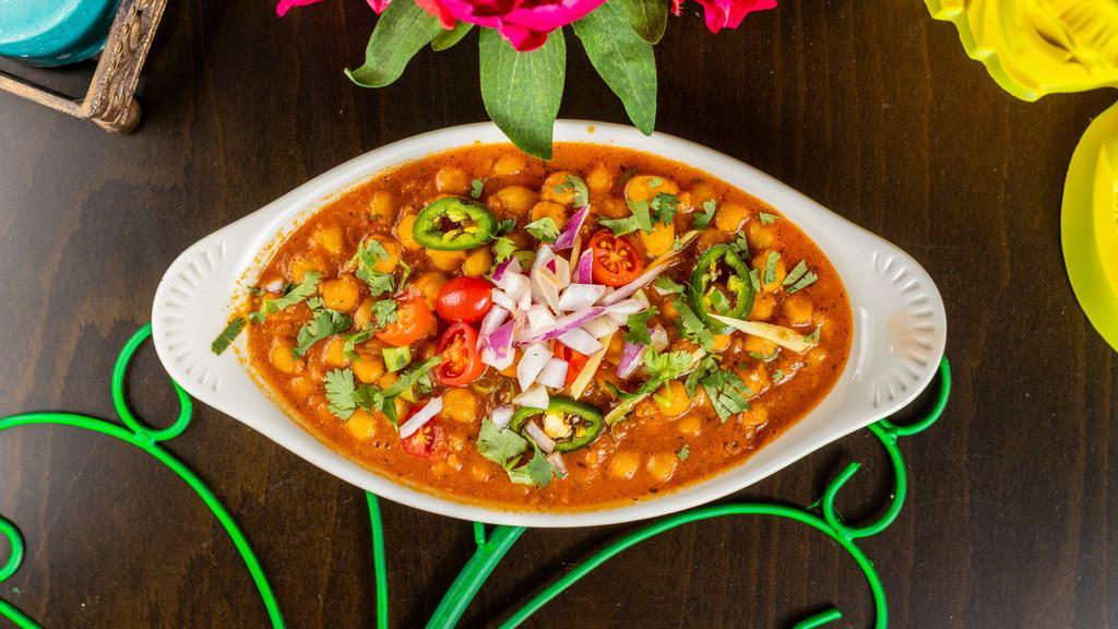 Chana Masala · Chick peas slow simmered with freshly ground onions, tomatoes, ginger & garlic Punjabi style.