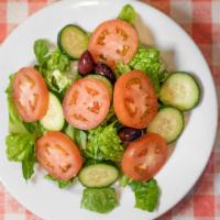 House Salad · Iceberg lettuce mixed with sliced cabbage and carrots topped with chopped tomatoes, slice cu...