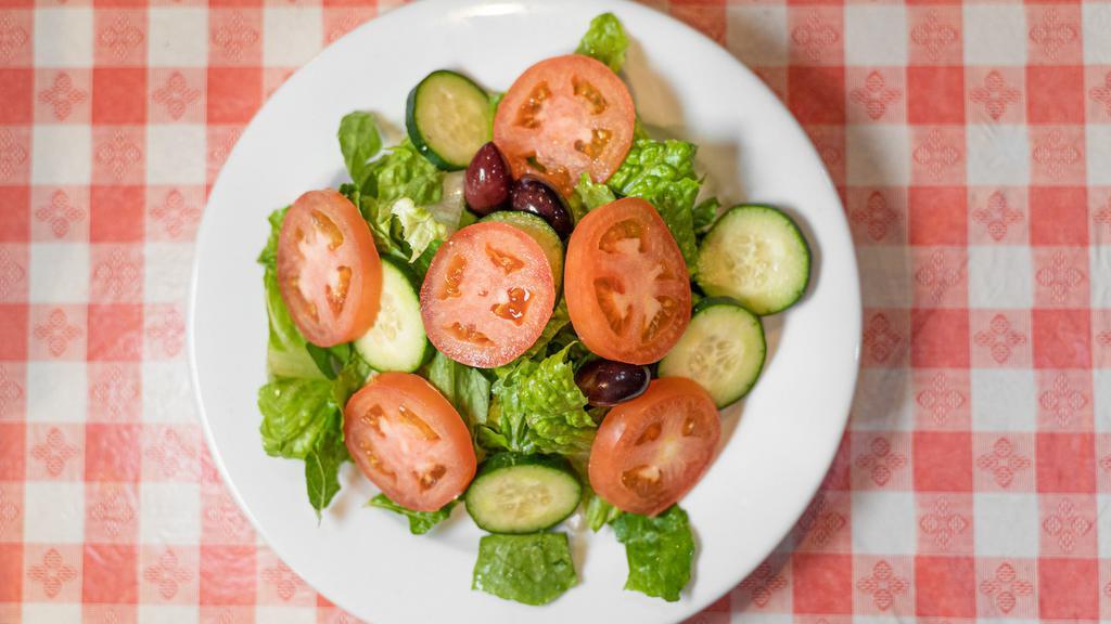 House Salad · Iceberg lettuce mixed with sliced cabbage and carrots topped with chopped tomatoes, slice cucumbers and olives.