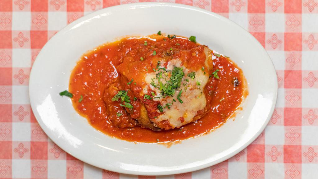 Chicken Parmigiana · Breaded chicken in tomato sauce with melted mozzarella cheese. Served with pasta.