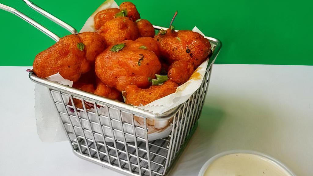 Buffalo Cauliflower Appetizer · Our battered cauliflower (not gluten free) tossed in our house-made buffalo sauce (contains dairy) served with a size of our house-made lime bleu cheese sauce.