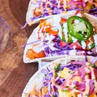 Tiki Tacos · Gluten-free corn tortillas, Napa cabbage, pineapple, pickled onions, Spicy Shaka sauce