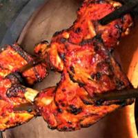 Chicken Tandoori · Entrée. Chicken parts marinated with herbs and spices, served with rice and salad.