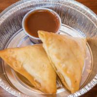 Vegetable Samosa (2 Pieces) · Baked pastry with potato and pea filling.