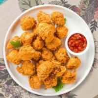 Chicken Popcorn · Bite-size pieces of chicken breaded and fried until golden brown.