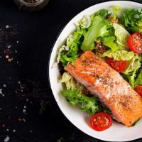Baked Salmon Platter · Baked salmon platter served with lettuce, tomatoes, Bermuda onion, bagel, and a choice of pl...