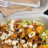Chicken Kebab Salad · Marinated chunks of grilled chicken breast served over a bed of lettuce with feta, fresh dic...