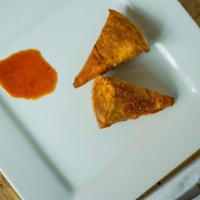 Vegetable Samosa · Crisp patties filled with spiced potatoes and peas.