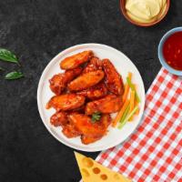 Buffalo Wings · Fresh chicken wings breaded, fried until golden brown, and tossed in buffalo sauce.