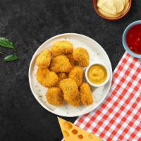 Chicken Nuggets · Bite sized nuggets of chicken breaded and fried until golden brown.