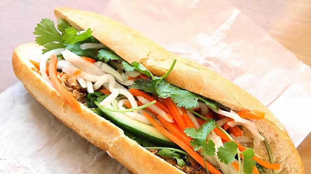 Brisket Banh Mi · Slow roasted beef layered pickled carrots daikon, cucumbers, cilantro & Sriracha aioli hoisin sauce with a pho beef broth for dip.