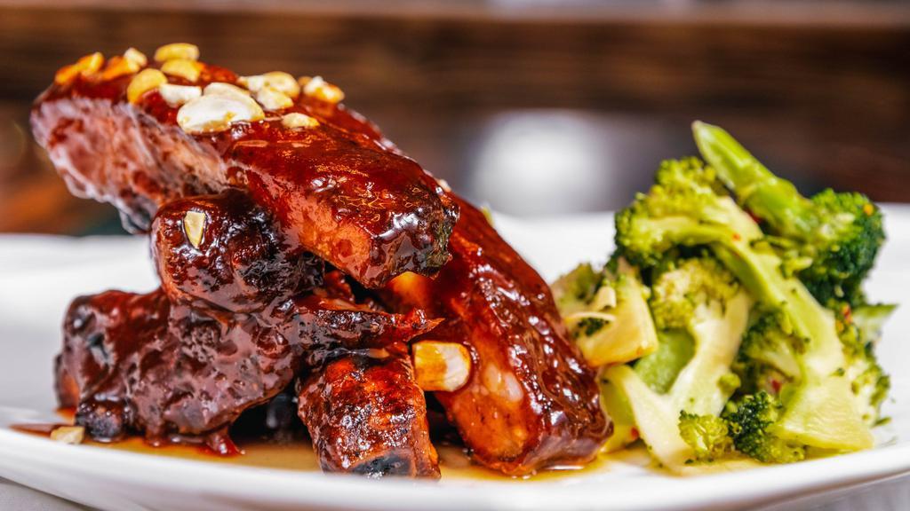 Sticky Fingers Ribs · 6-bone Slow smoked Pork spare ribs sweet and tangy BBQ sauce,  roasted cashew and scallion, pickled broccoli.