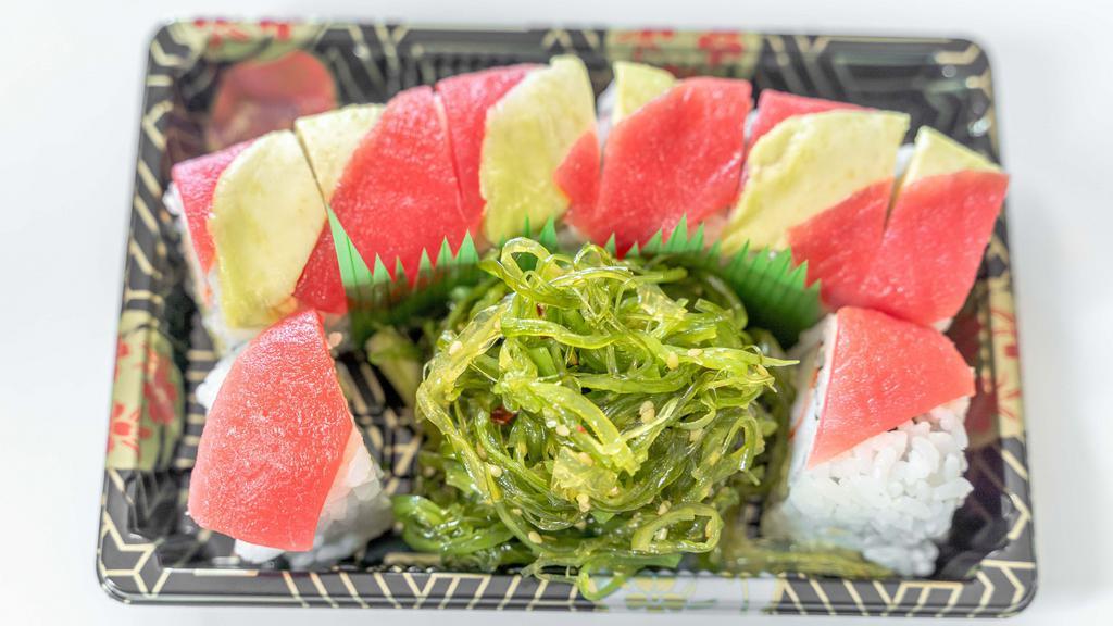 Jr31. Sultan Roll · Shrimp, crab cake, avocado and cucumber inside. Avocado and fresh tuna on top served with seaweed salad.