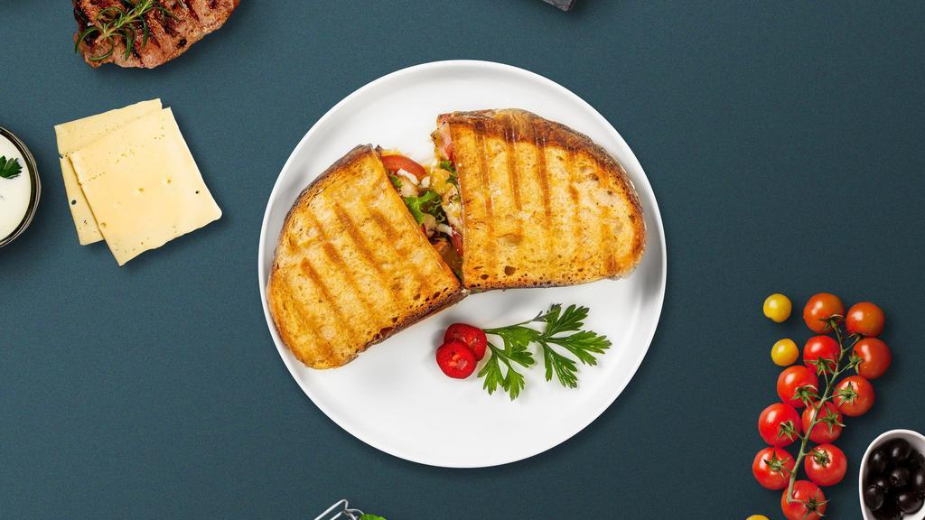 Grilled Cluck Panini · Grilled chicken, melted cheese, lettuce, and tomato served on your choice of toasted bread.