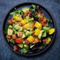 Mango Avocado Salad · Spring mix salad with mango, avocado, cucumbers, tomatoes and citrus ponzu.