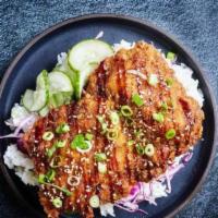 Donkatsu Rice Bowl · Lightly fried chicken cutlet with cabbage, pickled cucumbers, sesame seeds, rice and donkats...