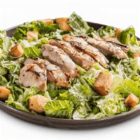 Chicken Caesar Salad · Crisp romaine lettuce topped with sliced, grilled chicken breast and Caesar dressing on the ...